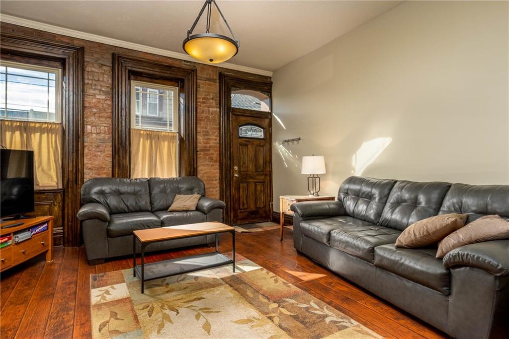 838 Spring Garden Avenue Pittsburgh, PA 15212 - Photo 3 of 24 a living room with furniture a window and a flat screen tv
