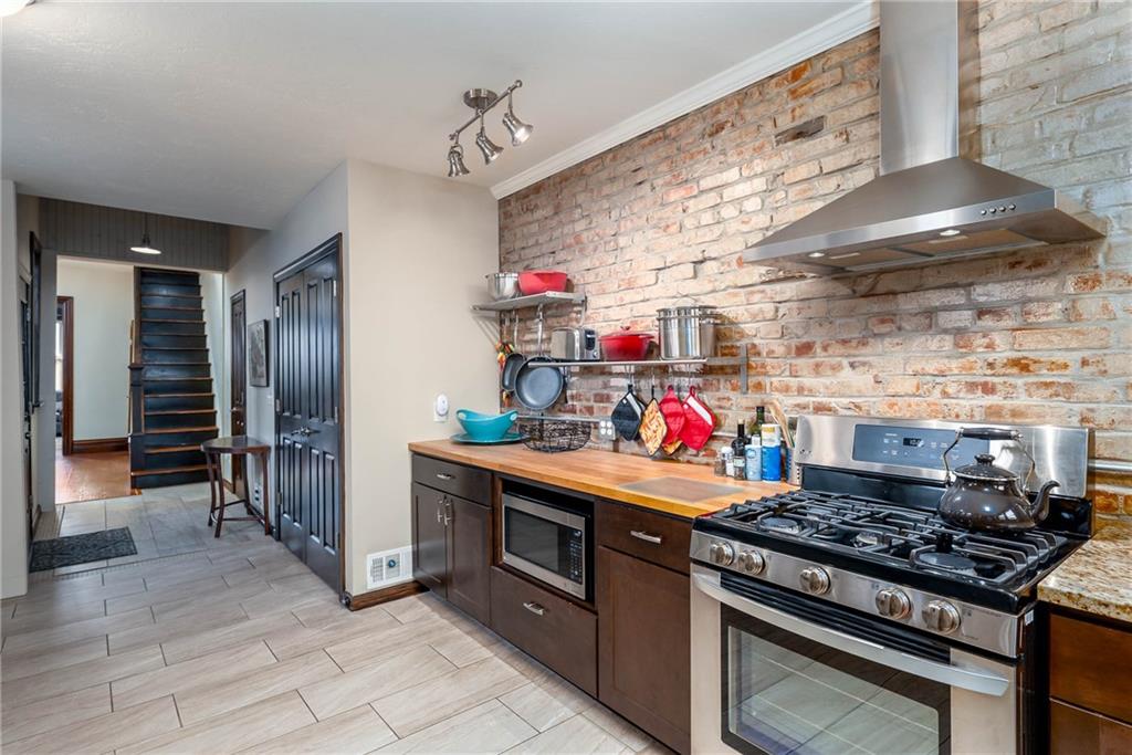 838 Spring Garden Avenue Pittsburgh, PA 15212 - Photo 10 of 24 a kitchen with stainless steel appliances granite countertop a stove and a refrigerator