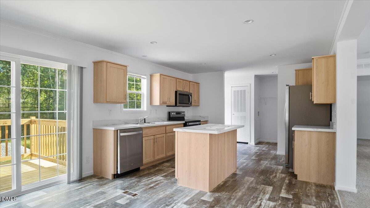 212 Ellington's Path Henderson, NC 27537 - Photo 10 of 36 a kitchen with a sink a counter top space and stainless steel appliances