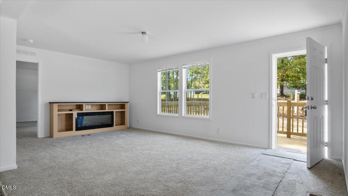 212 Ellington's Path Henderson, NC 27537 - Photo 11 of 36 a view of empty room with a fireplace