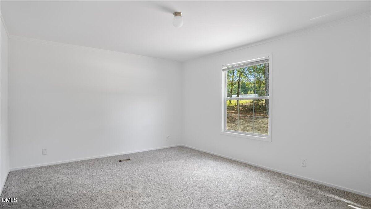 212 Ellington's Path Henderson, NC 27537 - Photo 13 of 36 an empty room with a window