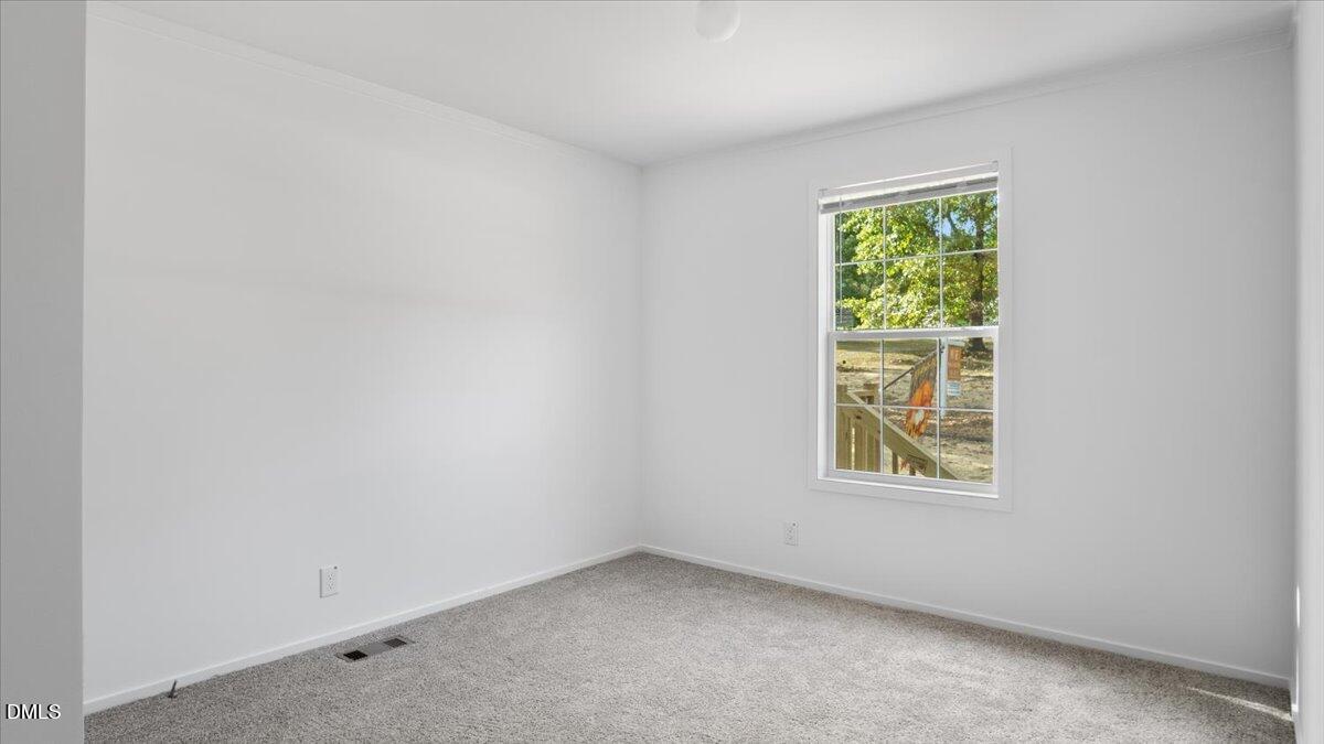 212 Ellington's Path Henderson, NC 27537 - Photo 19 of 36 an empty room with a window