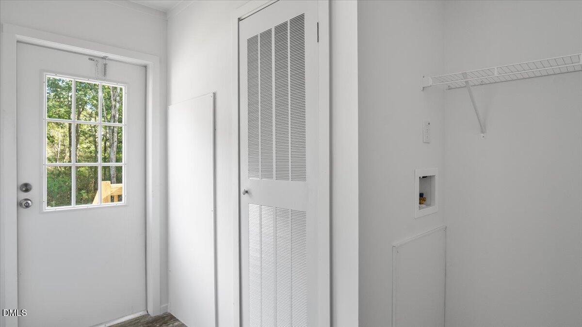 212 Ellington's Path Henderson, NC 27537 - Photo 22 of 36 a view of a closet area with a window