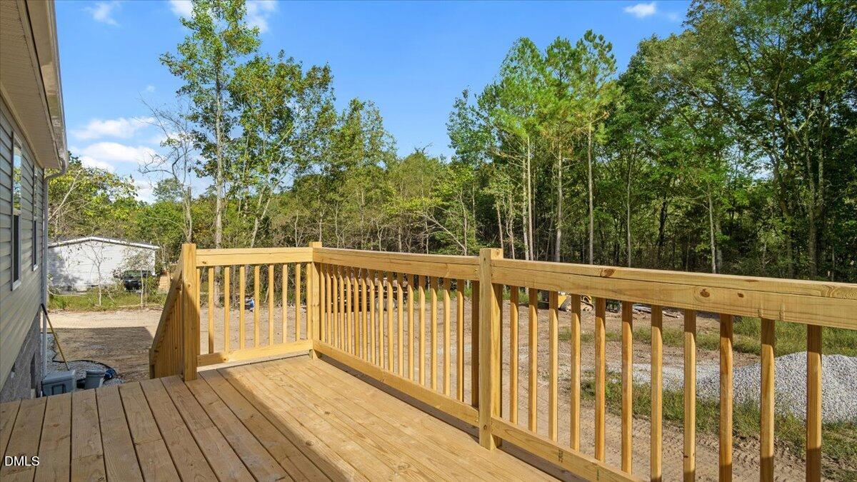 212 Ellington's Path Henderson, NC 27537 - Photo 26 of 36 a view of balcony with wooden floor and fence