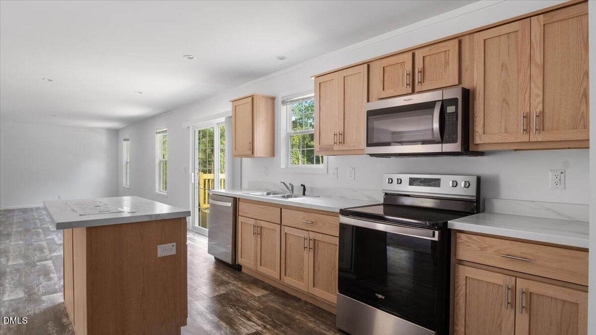 212 Ellington's Path Henderson, NC 27537 - Photo 4 of 36 a kitchen with stainless steel appliances granite countertop a sink stove microwave and refrigerator