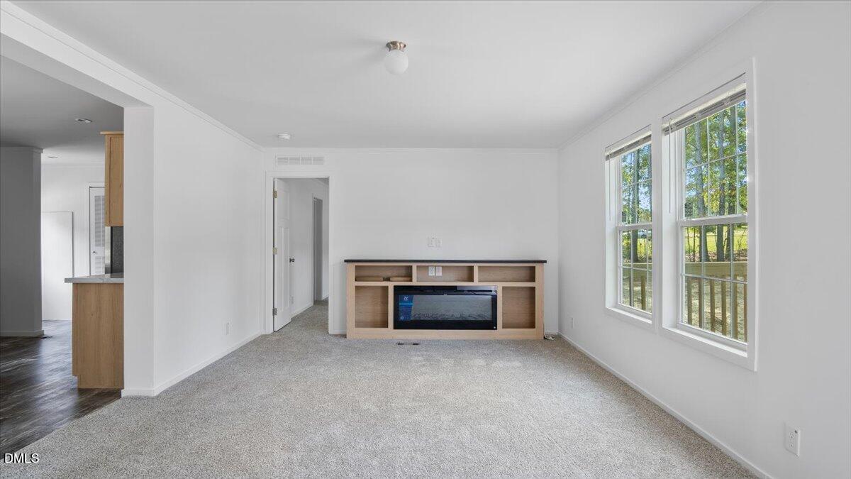 212 Ellington's Path Henderson, NC 27537 - Photo 6 of 36 an empty room with furniture and a window