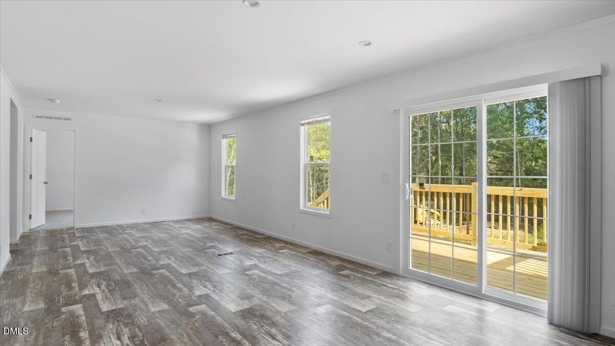 212 Ellington's Path Henderson, NC 27537 - Photo 7 of 36 a view of an empty room with a window