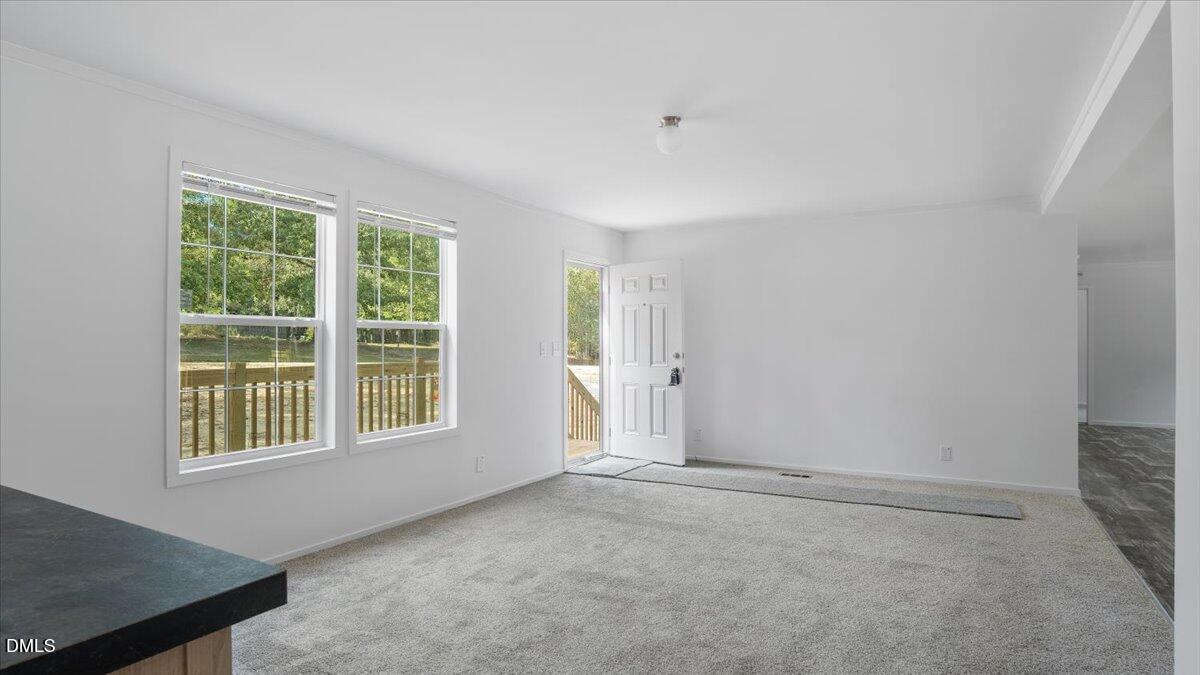 212 Ellington's Path Henderson, NC 27537 - Photo 8 of 36 an empty room with windows