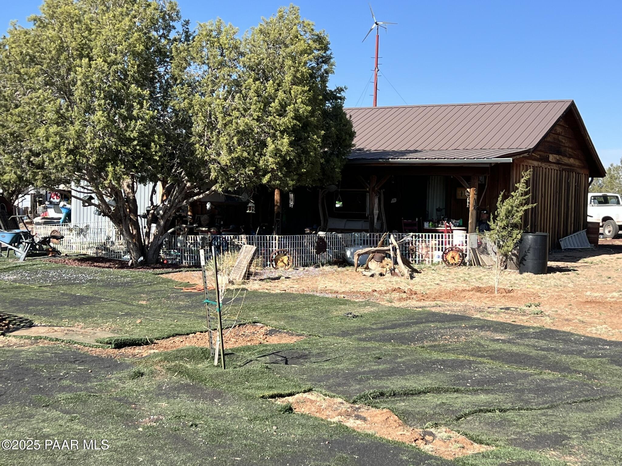 a backyard of a house with yard and outdoor seating