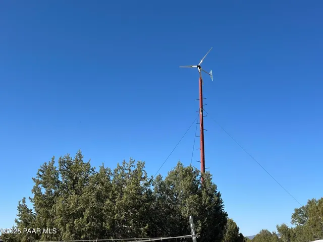 a night view of a building with a tree in the background