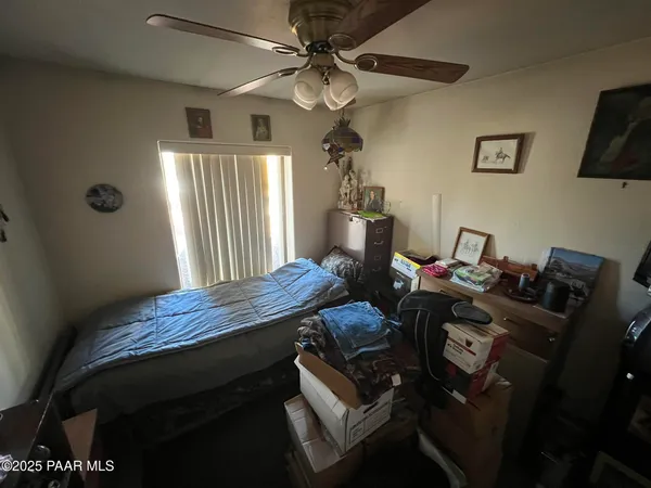 a bed room with a bed and a chandelier