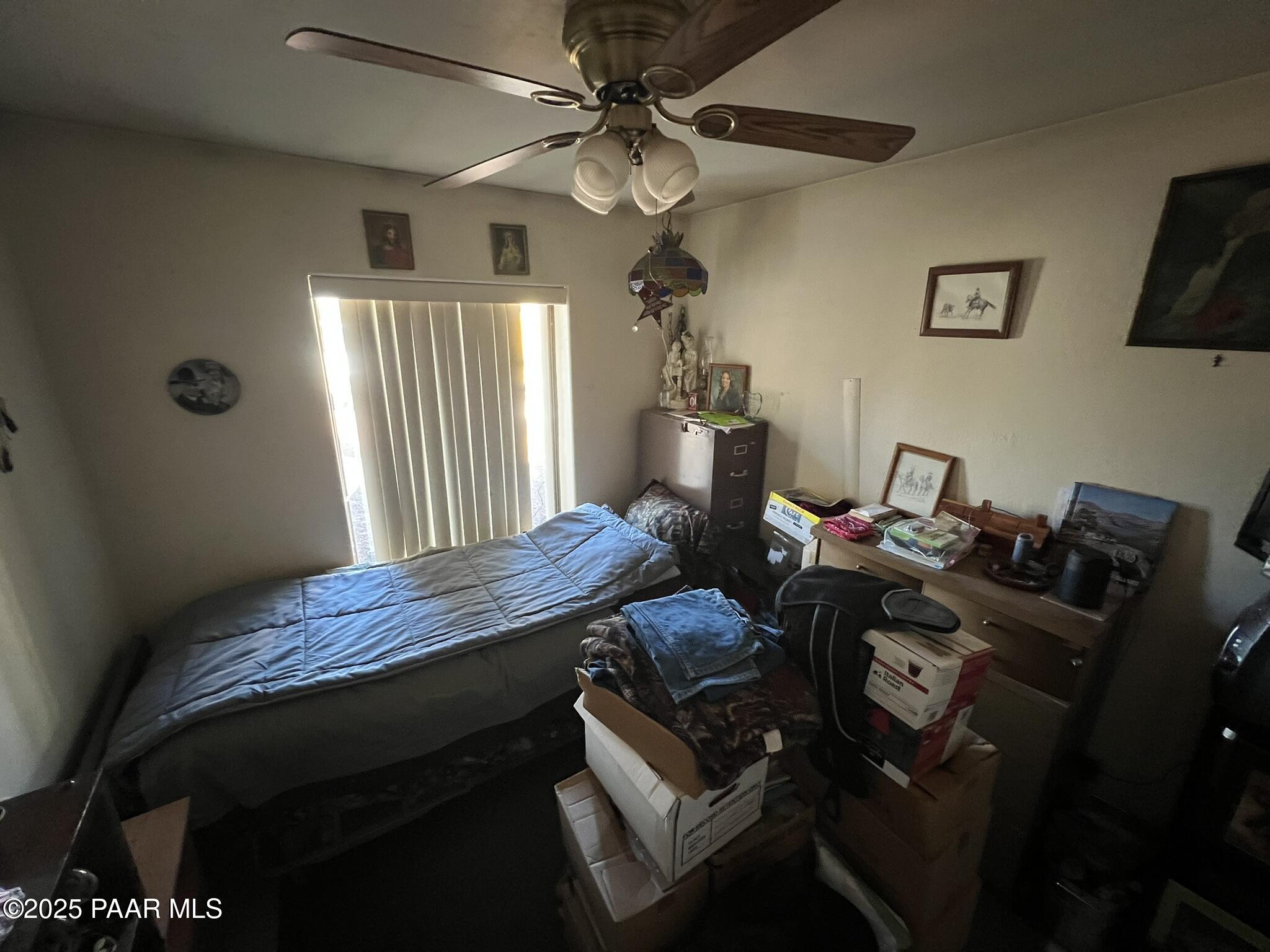 314 Bullock Road Ash Fork, AZ 86320 - Photo 8 of 33 a bed room with a bed and a chandelier