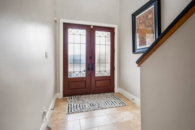a kitchen with a table chairs stove and wooden floor