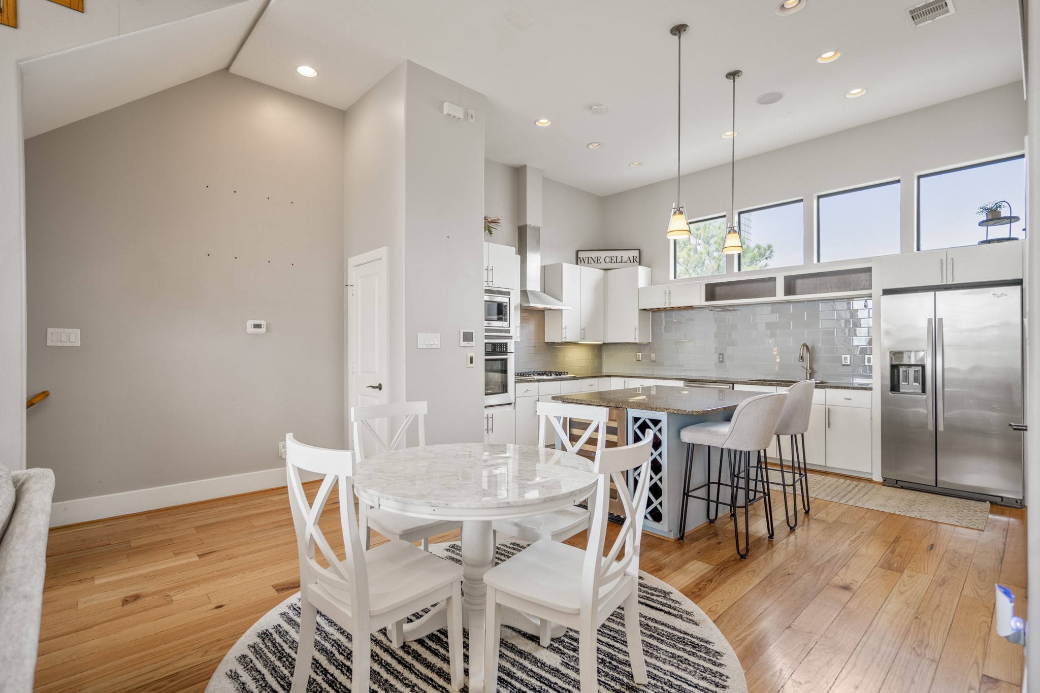 1310 West Dallas Street Houston, TX 77019 - Photo 18 of 50 a view of a dining room and livingroom with furniture wooden floor kitchen chandelier
