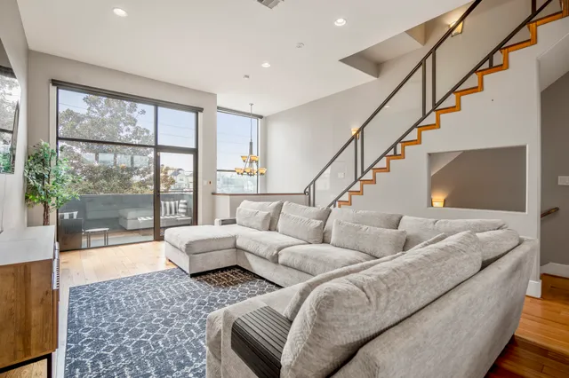 a living room with furniture and kitchen view