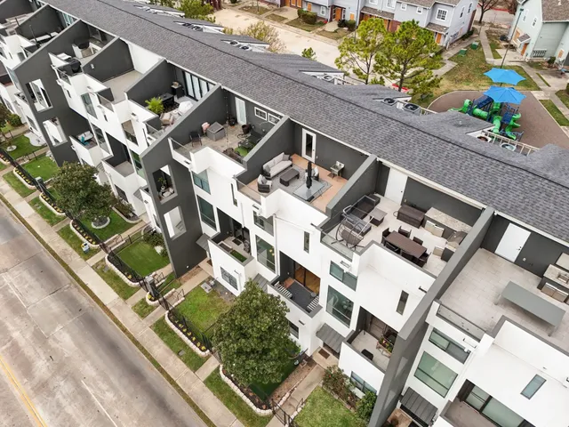 an aerial view of a residential apartment building with a yard