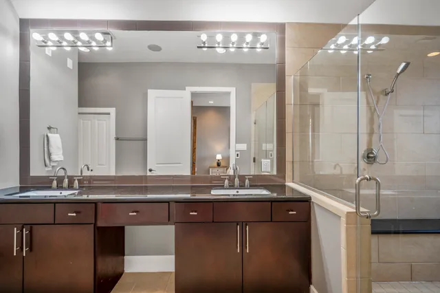 a bathroom with a granite countertop sink mirror and double
