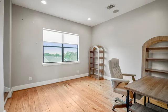 a view of a room with wooden floor and chair