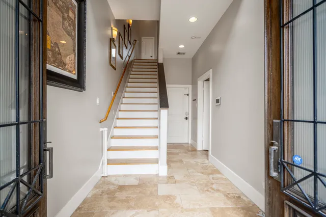 a view of a hallway with wooden floor and cabinet