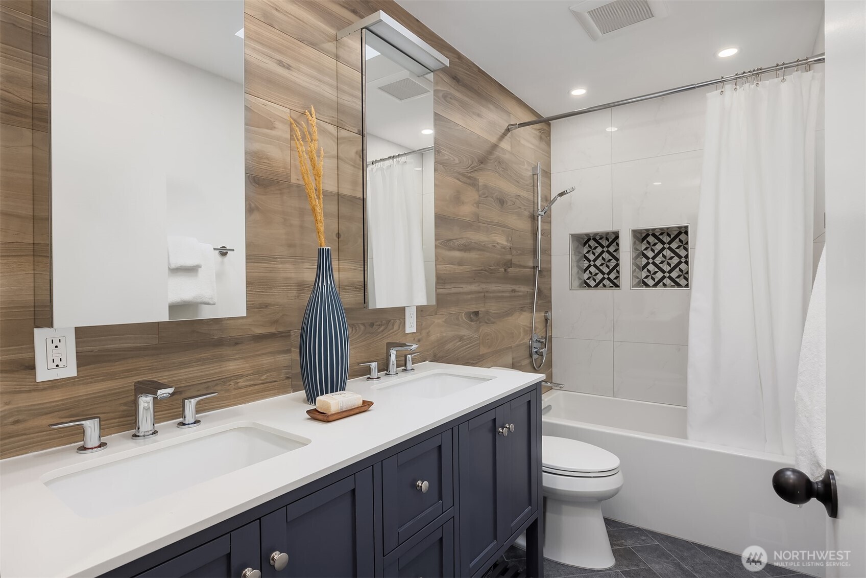 5340 West Mercer Way Mercer Island, WA 98040 - Photo 26 of 36 a bathroom with a double vanity sink toilet and shower