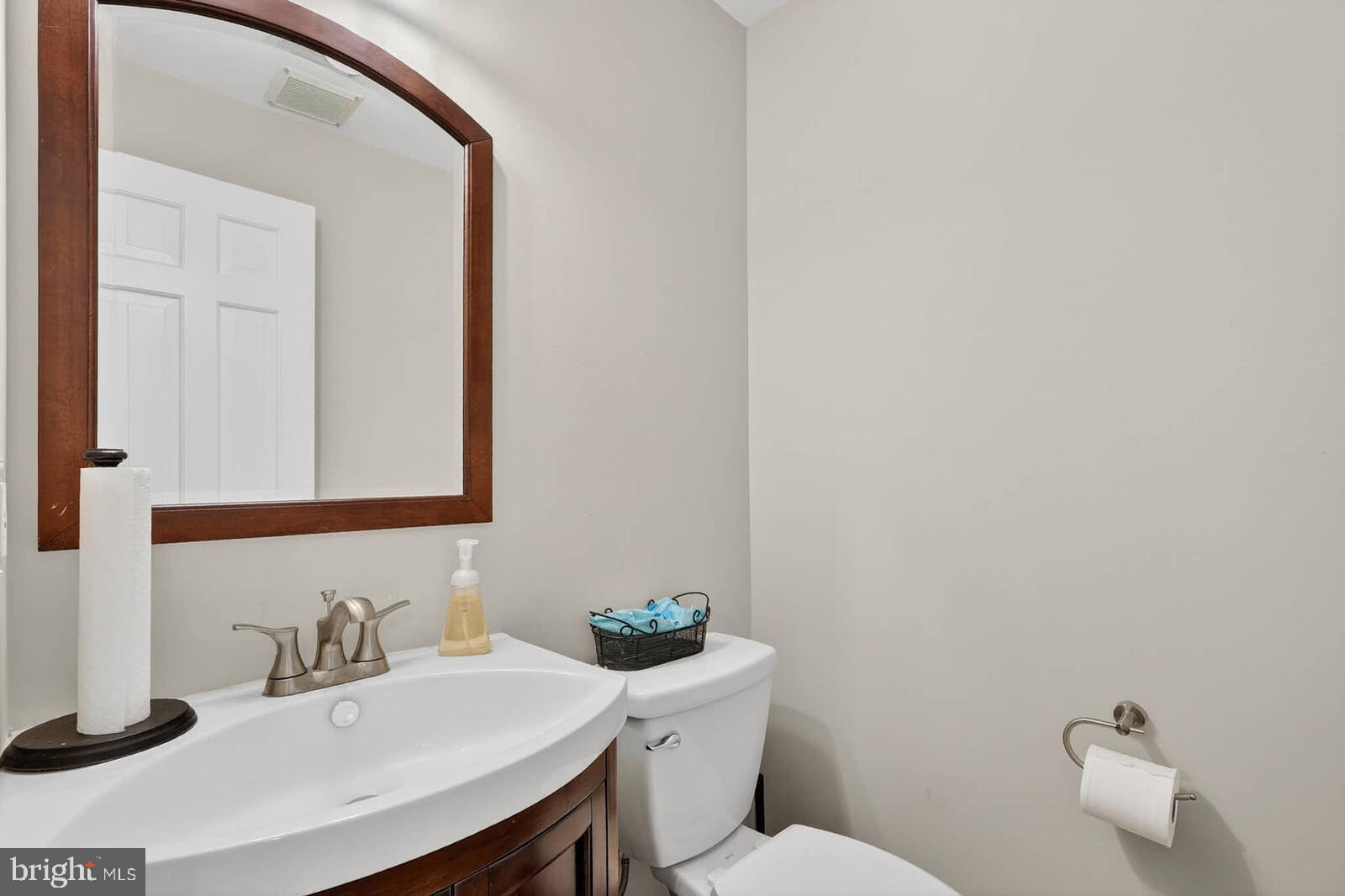 500 Finsbury Road Silver Spring, MD 20904 - Photo 32 of 54 a bathroom with a sink a toilet and mirror