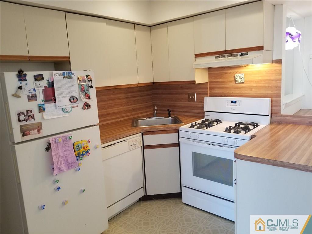 197 Evergreen Road, Unit 5B Edison, NJ 08837 - Photo 4 of 11 a white refrigerator freezer sitting inside of a kitchen