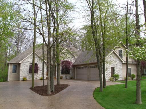 4174 River Ridge Sandwich, IL 60548 - Photo 1 of 16 a front view of a house with a garden and trees
