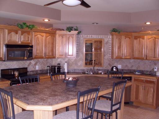 4174 River Ridge Sandwich, IL 60548 - Photo 4 of 16 a kitchen with a table chairs sink and cabinets