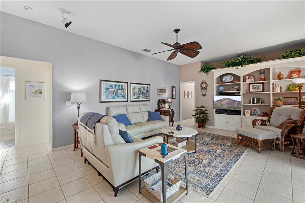 21516 Langholm Run Estero, FL 33928 - Photo 14 of 50 a living room with furniture and wooden floor