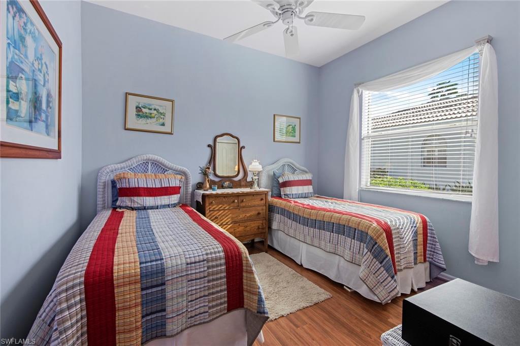 21516 Langholm Run Estero, FL 33928 - Photo 21 of 50 a bedroom with two beds and a chandelier