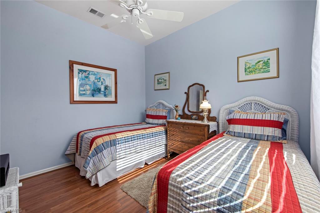 21516 Langholm Run Estero, FL 33928 - Photo 22 of 50 a bedroom with a bed and a chandelier