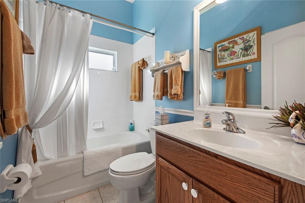 21516 Langholm Run Estero, FL 33928 - Photo 23 of 50 a bathroom with a sink a toilet a mirror and shower