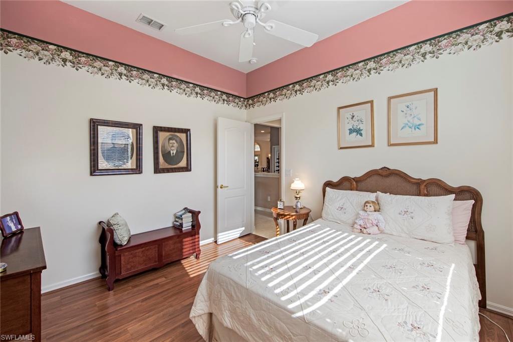 21516 Langholm Run Estero, FL 33928 - Photo 25 of 50 a bedroom with furniture and wooden floor
