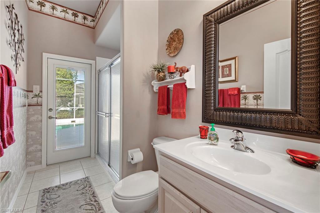 21516 Langholm Run Estero, FL 33928 - Photo 28 of 50 a bathroom with a sink vanity mirror and toilet