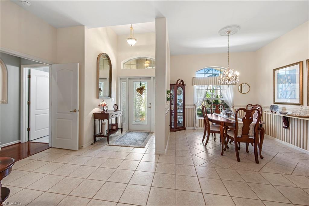 21516 Langholm Run Estero, FL 33928 - Photo 4 of 50 a dining room filled with furniture and chandelier