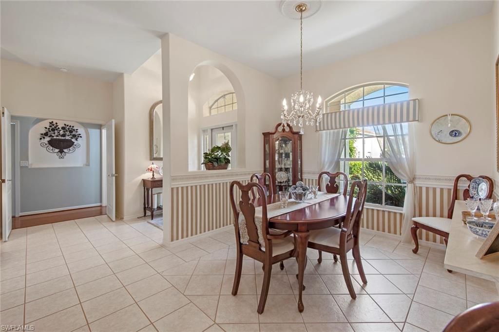 21516 Langholm Run Estero, FL 33928 - Photo 6 of 50 a view of a dining room with furniture and chandelier