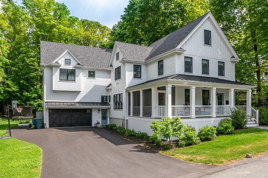 68 Crest Road Wellesley, MA 02482 - Photo 1 of 4 a front view of a house with a garden and plants