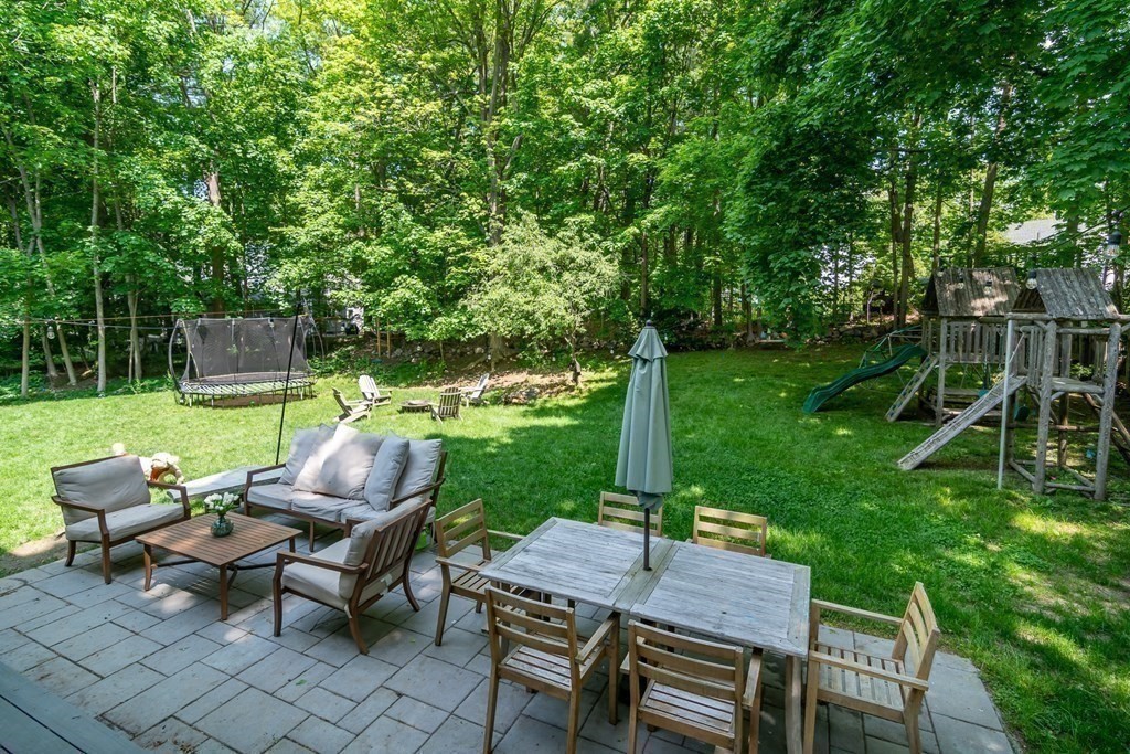 68 Crest Road Wellesley, MA 02482 - Photo 3 of 4 a view of a patio with table and chairs potted plants and large tree