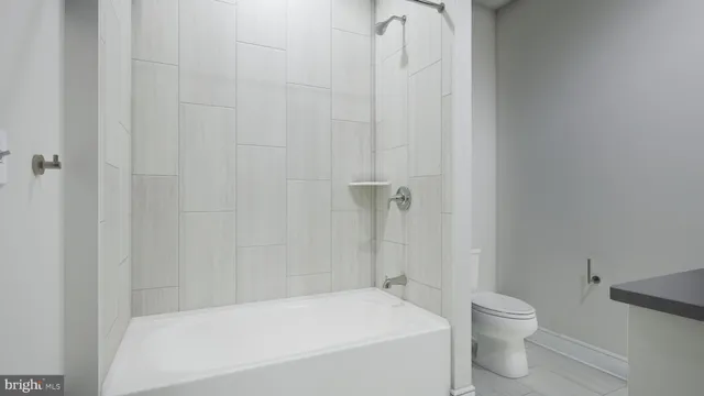 a bathroom with a bathtub and toilet