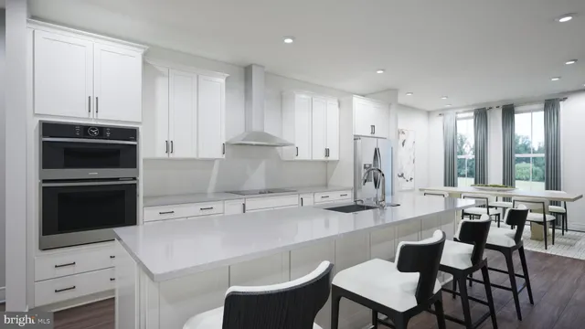a kitchen with a dining table chairs appliances and cabinets