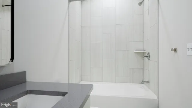 a bathroom with a toilet and a bath tub