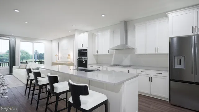 a kitchen with a dining table chairs appliances and cabinets