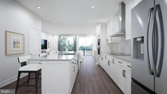 a large kitchen with stainless steel appliances a sink and cabinets