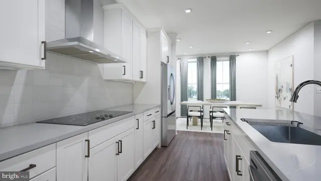 a kitchen with granite countertop a sink stove and cabinets