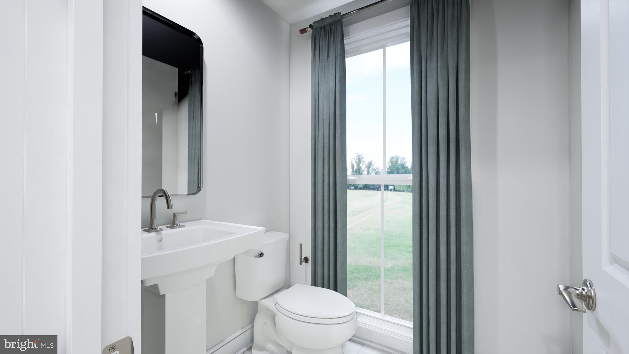 9759 Grant Avenue Manassas, VA 20110 - Photo 10 of 32 a bathroom with a toilet a sink and a mirror