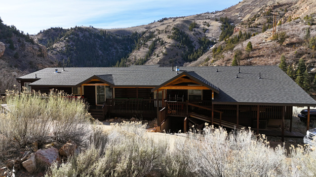 7500 Spring Canyon Road Helper, UT 84526 - Photo 4 of 83 Back of property featuring a shingled roof and a deck with mountain view