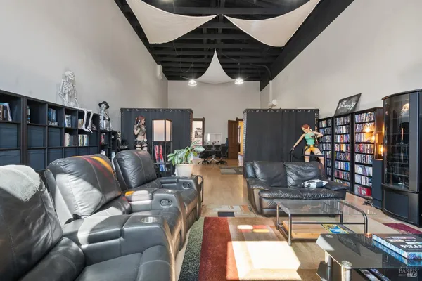a living room with furniture and a flat screen tv with wooden floor