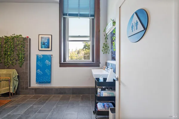a kitchen with stainless steel appliances granite countertop a sink a stove and a refrigerator