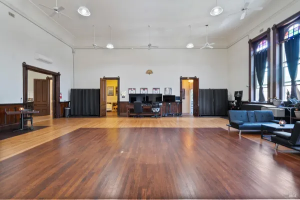 a view of a living room with kitchen furniture and a flat screen tv