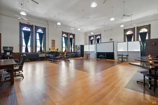 a view of a livingroom with dining room and wooden floor
